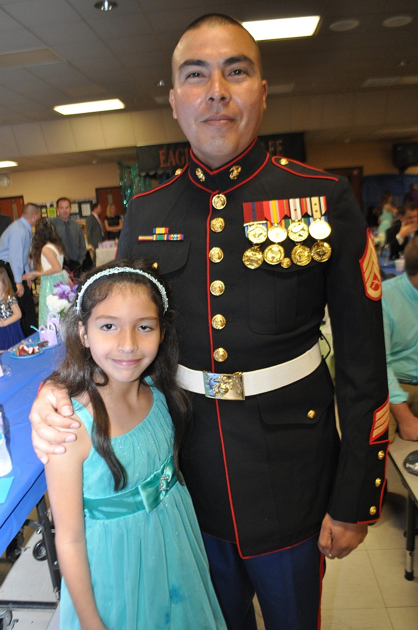 U.S. Marines Ret. Staff Sgt. Angel Alejandre attends with his daughter, Isabela.
