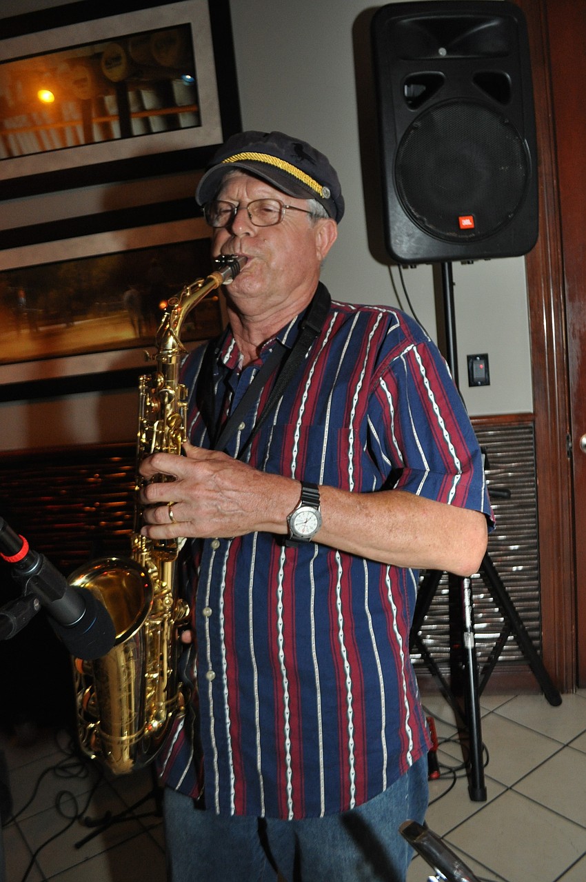 Gumbo Boogie Band saxophonist Ken Smith performs.