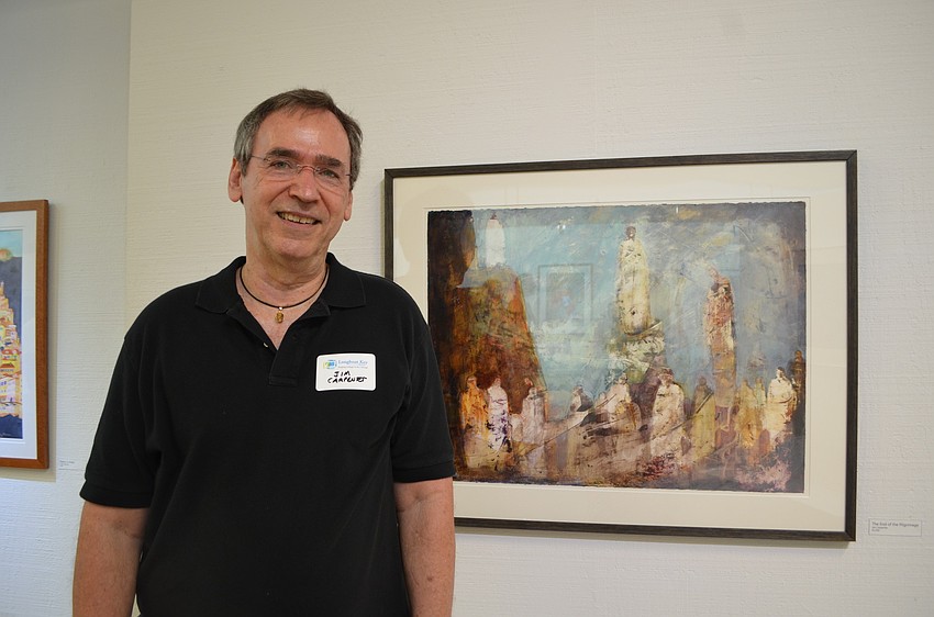 Jim Carpenter with his work, â€œThe End of the Pilgrimage.â€ Instead of creating art from an idea, Carpenter paints intuitively and lets his paintings evolve as he works.