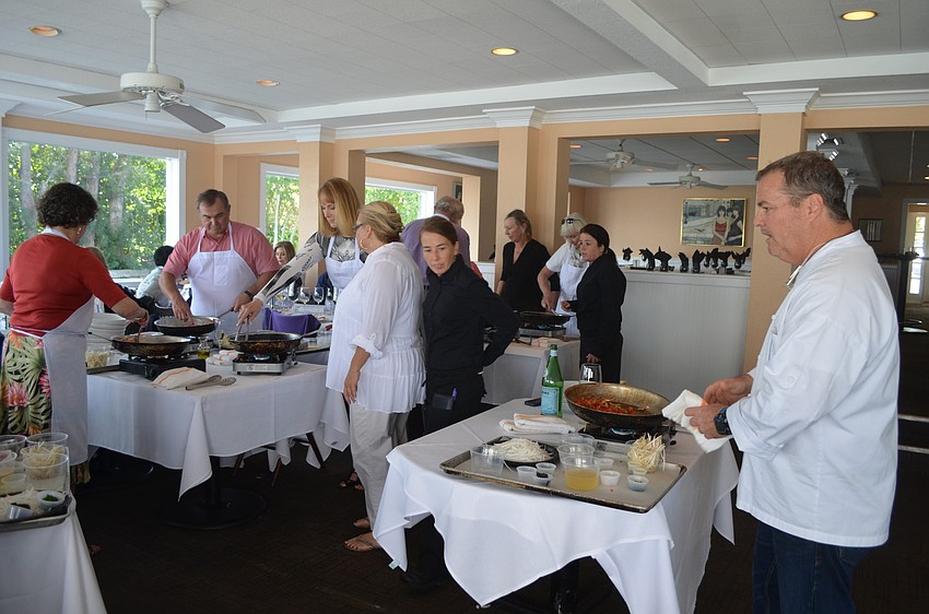 Owner Tommy Klauber instructs guests on making spicy mint noodles with shrimp.