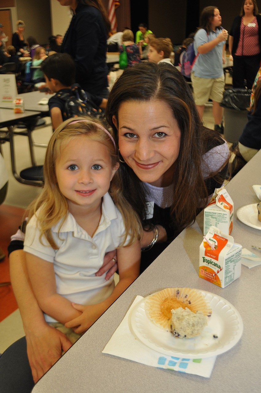 Brooklyn Hauenstein enjoys a blueberry muffin with her mom, Sara.