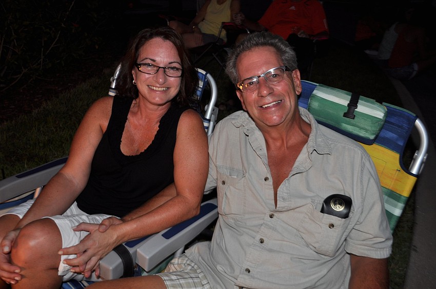Milena Dini and Anthony Buono listen to music.