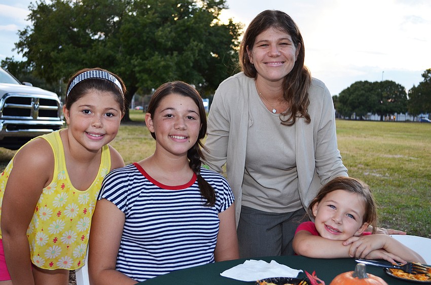 Rachel Williamson and her daughters Olivia, Anna and Ruby sample plates at the gala.