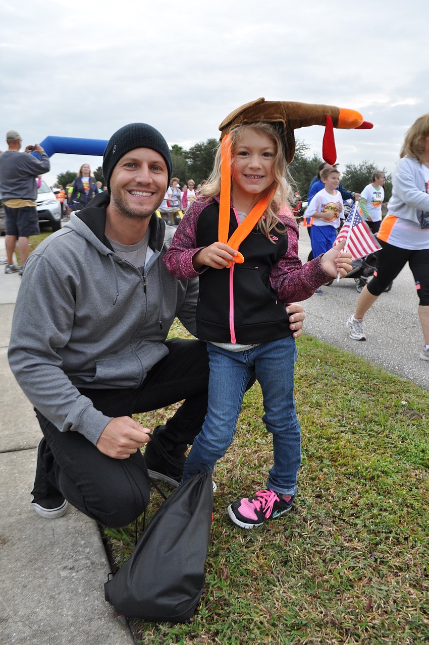 Ali Dalsing, with her dad, Jayme, cheers on her mother, Nichole, not pictured.