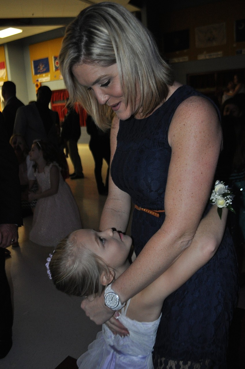Daphne Dauphas gives a hug and dances with her mom, Ellie.
