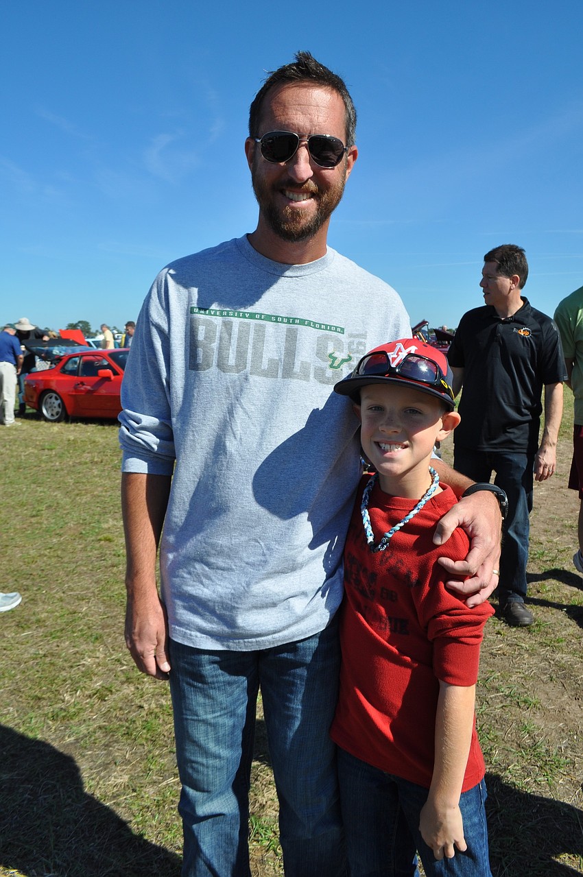 Grant Richardson, with his dad, Todd, says he lives the Ford Woody wagon, owned by his grandfather Paul Richardson, best.