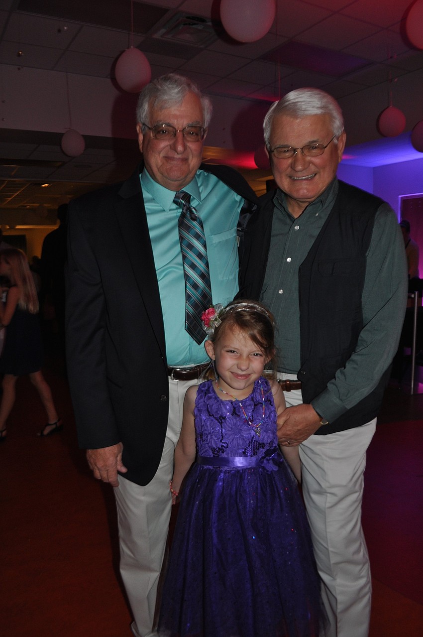 Ryann Gurski dances with her grandfathers, Dave Raterman, left, and John Gurski, right.