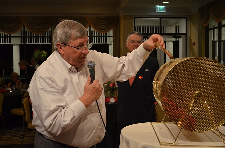 John Wild selects tickets for the raffle prizes.