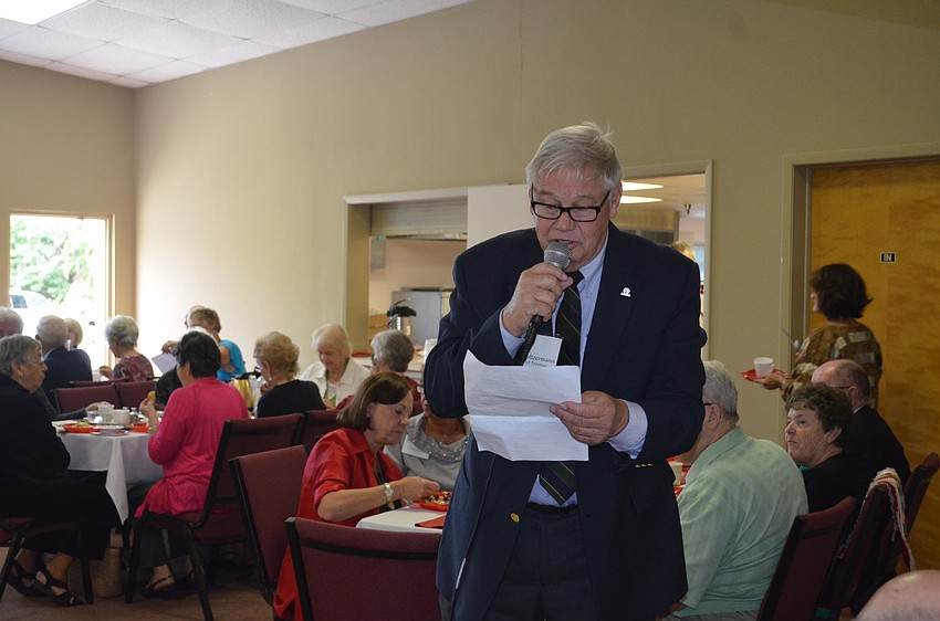 John Holtzermann auctions off cakes.