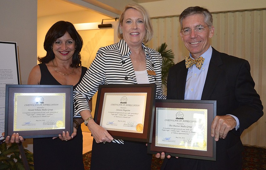 Laurie Gomes, Kelly Lavin and Matt Walsh hold their awards for media sponsorship.