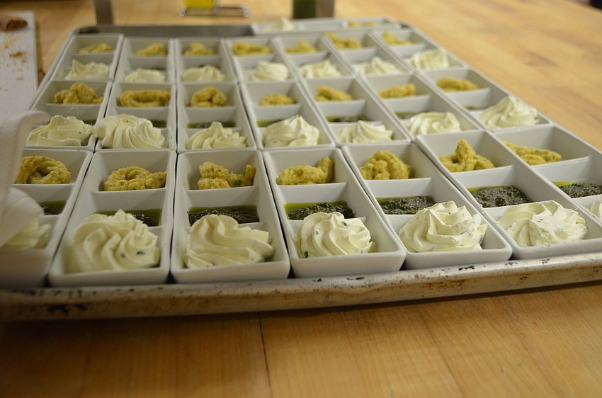 Each table is given bread along with three spreads: whipped butter, pesto and hummus.
