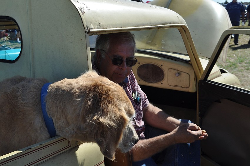 Stanley waits for a treat â€”Â a peanut â€” from his owner Ross Walkup, from the back of Walkup's 1947 Crosley pickup.