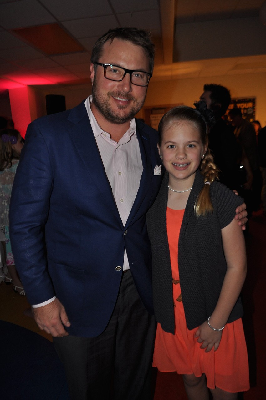 Jamie Ebling and his daughter, Ava, watch a contest.