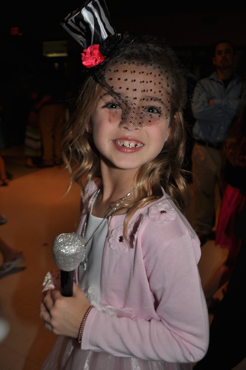 Meagan Coon, 8, dresses up for the photo both.