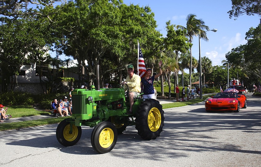 Steve Branham and his wife, Susan Phillips, add a John Deere tractor to the parade.
