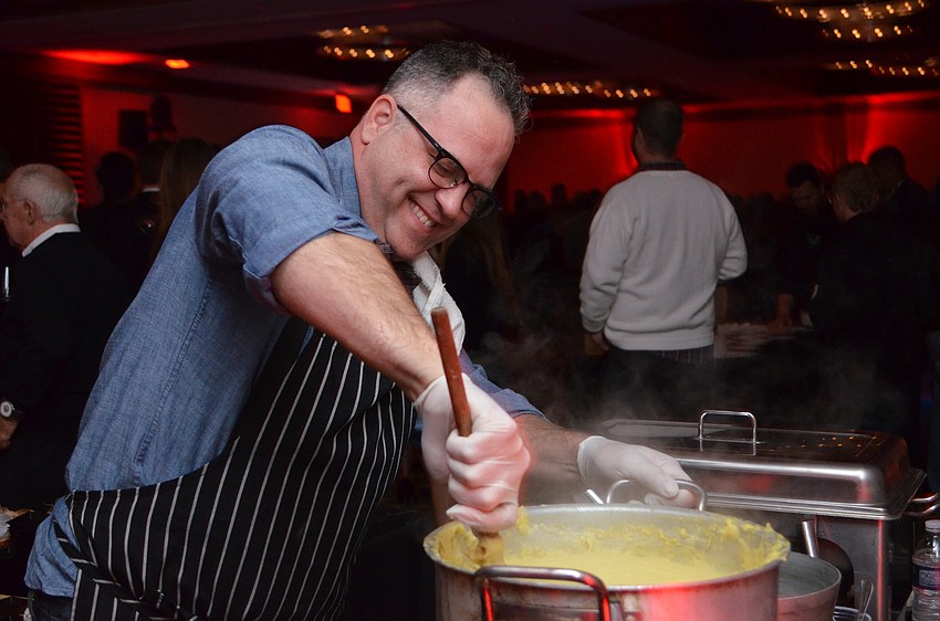 State Street Eating House Executive Chef, Christian Hershman stirs the creamy polenta that was served with the entrÃ©e.
