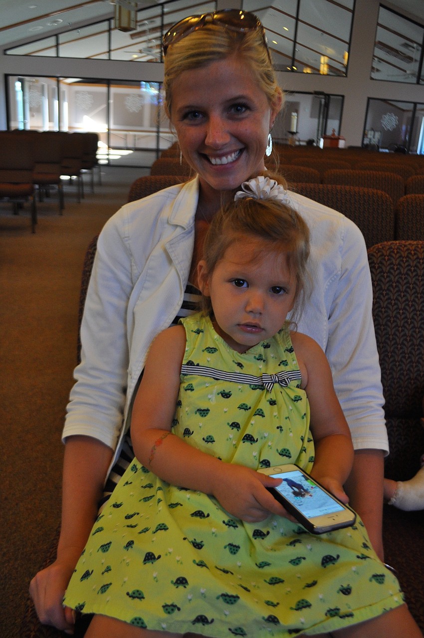 Amber Monserez and her daughter, Grace, await the start of the voluntary prekindergarten Motherâ€™s Day ceremony.