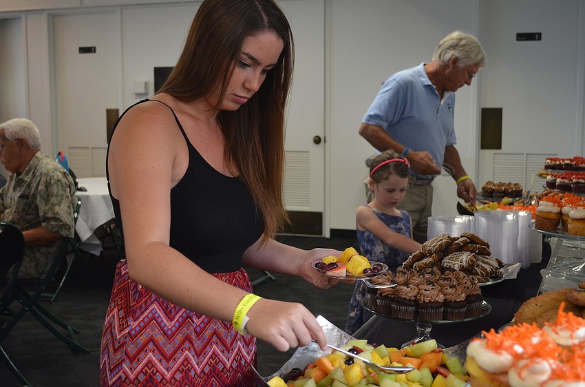 Delaney Capo serves herself some fruit.