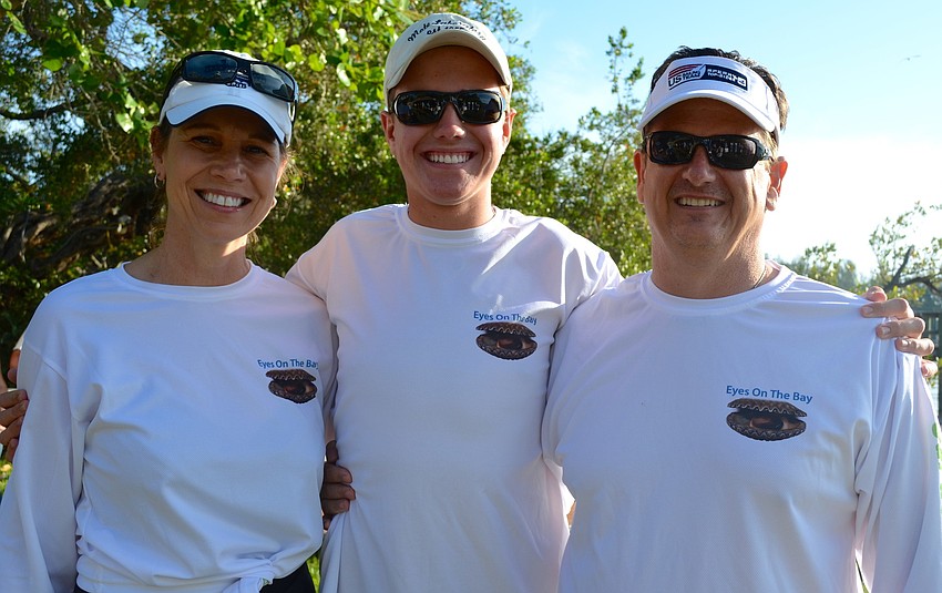 Returning volunteer Zack Jordan smiles between his parents, Yvonne and Clay