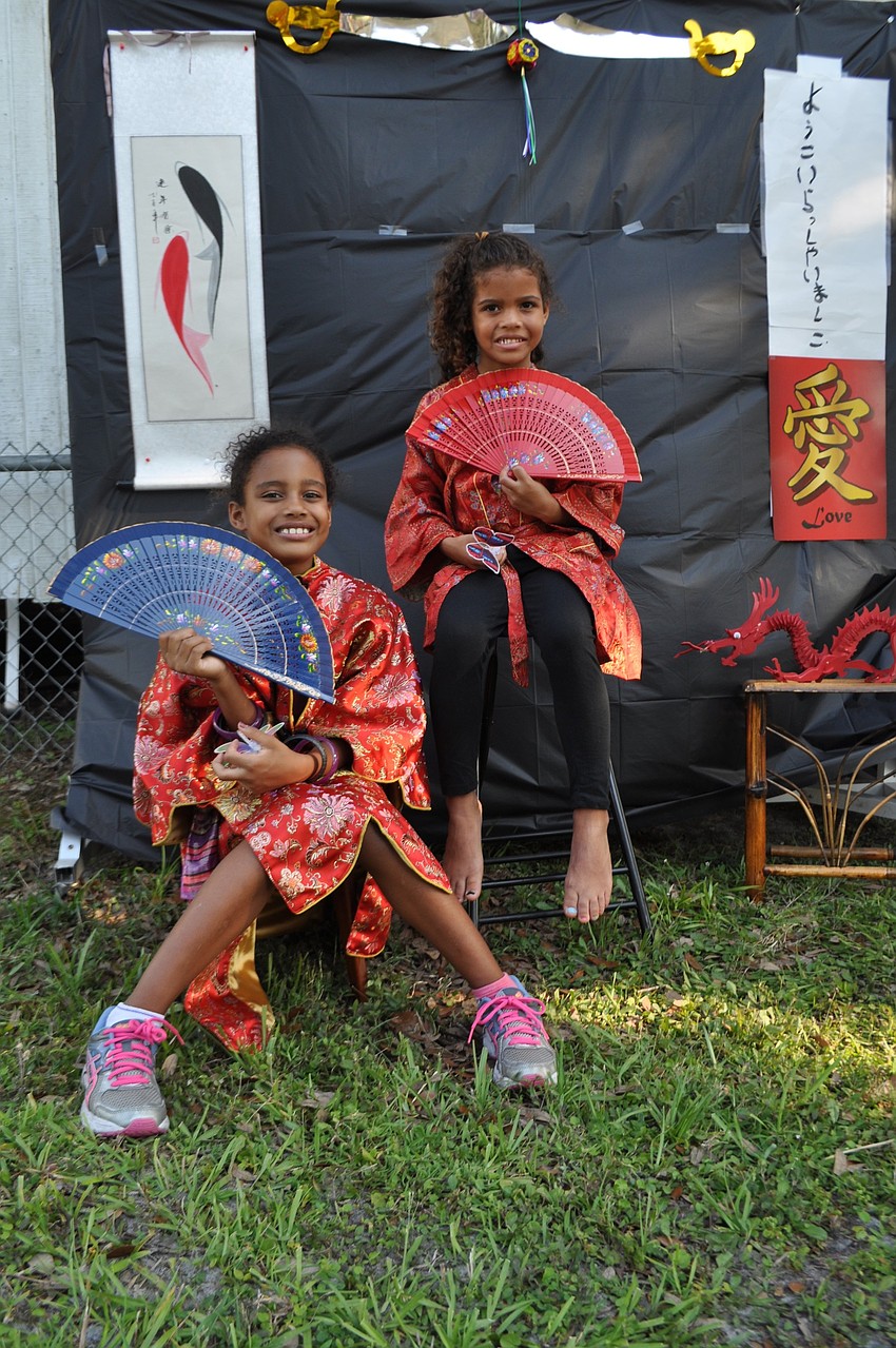 Taya Gaines and her sister, Mya, pose for a picture in costume.