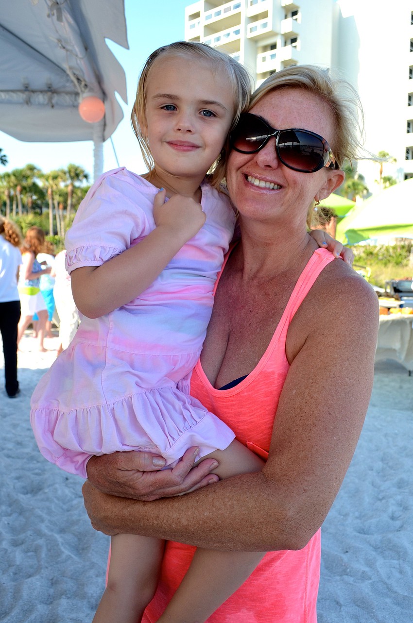 Monica Shea holds her daughter, Delaney, at the barbecue.