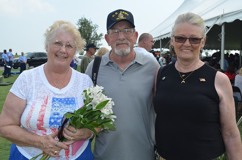Beverly Baker with Doug and Vivian Gibson visit Baker's late husband's grave.