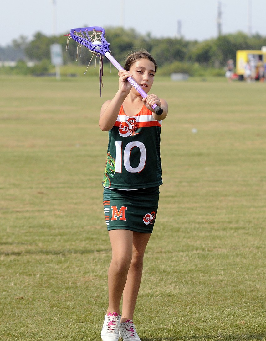 Nine-year-old Aspasia Markowski warms up before the start of her first competitive lacrosse tournament.