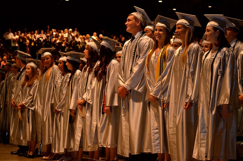 Members of the Class of 2014 listen to a rendition of the national anthem.