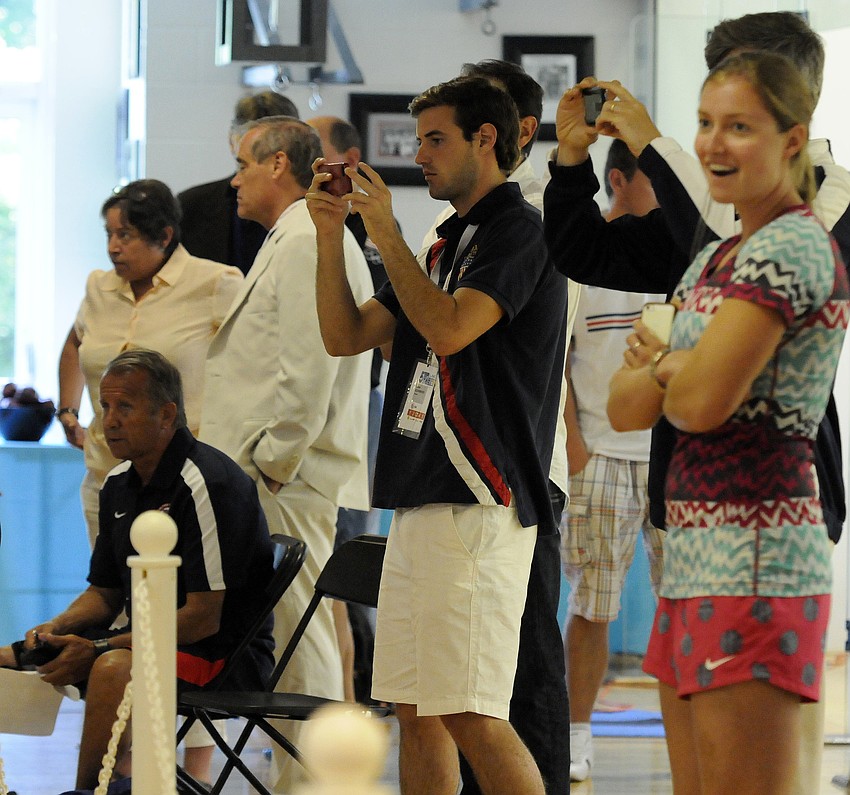 Members of the United States coaching staff and spectators cheer on the team during its bout with Belarus.