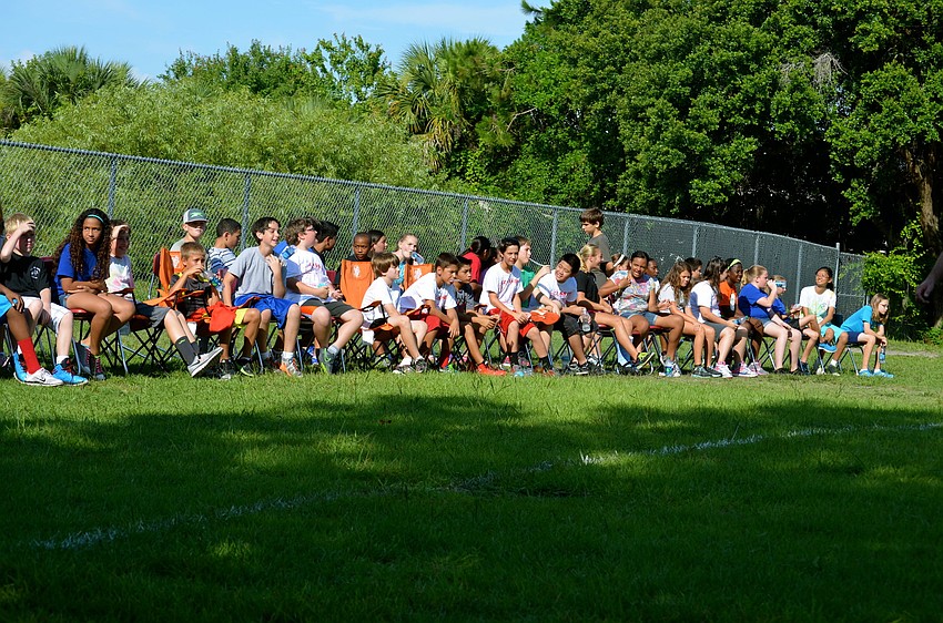Tara Elementary fifth-grade students cheer for their classmates from the sidelines.