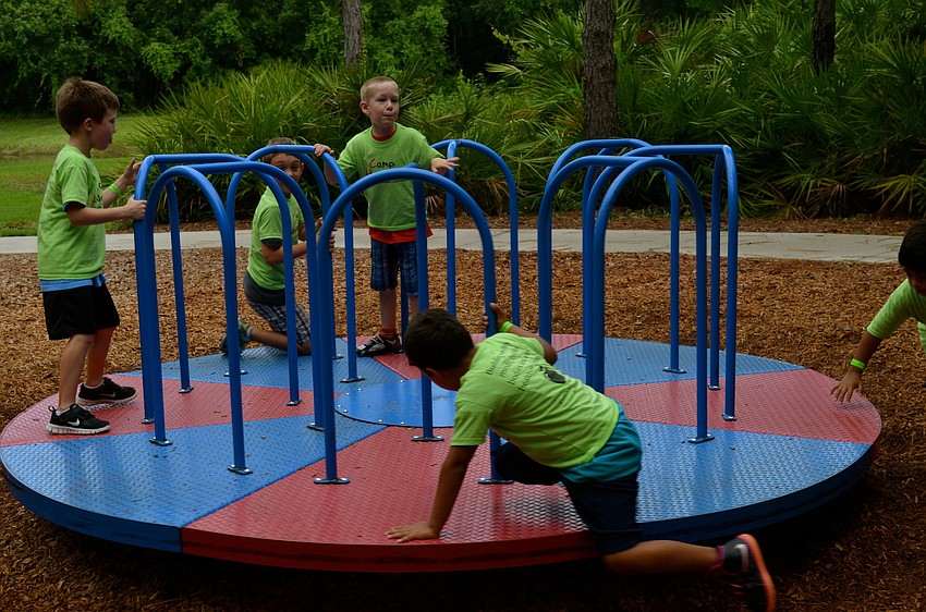 Campers race around on the playground.
