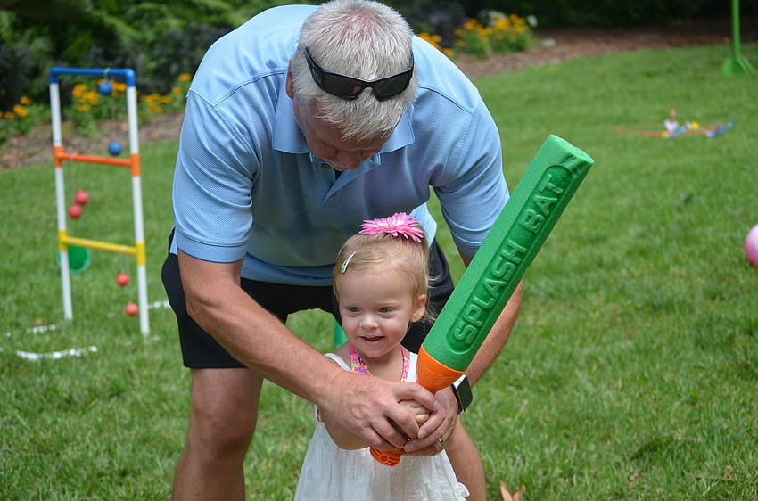 Jack Blood shows daughter, McKayla, how to play baseball.