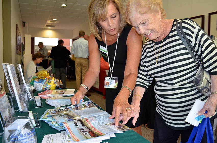 Allie Hueter talks to Jeanine Calleros at the Building Connections booth.