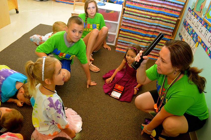 Brooke Burkhart participates in story time with volunteer Alexandra Padgett.