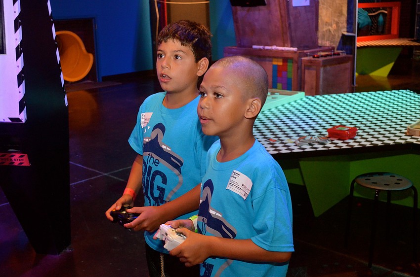 Nate Burnett and Jlynn Moore play video games.