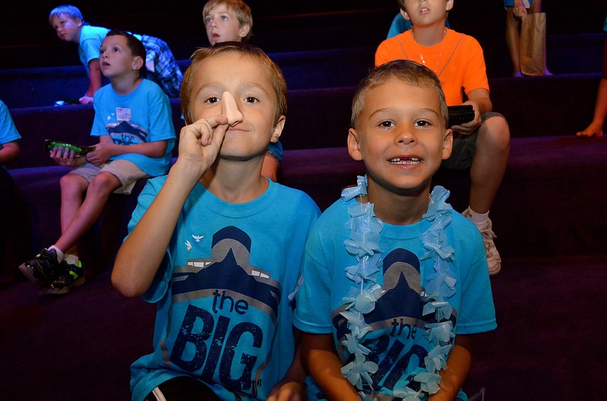 Connor Wright and Jonathan Phillips play around during a movie.