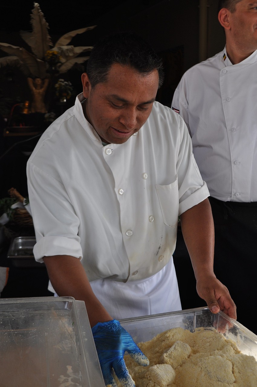 Fernando Gimenez breads catfish.