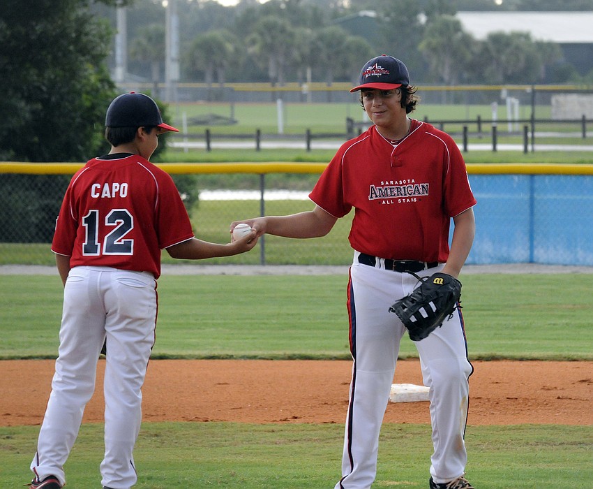 First baseman Jack Carney, right, turns the ball over to pitcher Josh Capo.