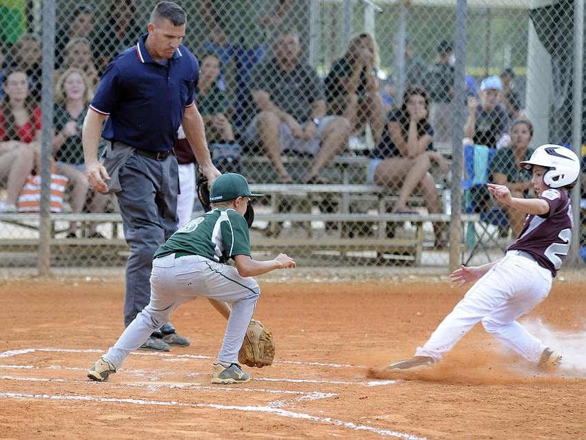Lakewood Ranch 10/11 pitcher Brady Greenamoyer catches Braden Riverâ€™s Connor Losada at home plate.