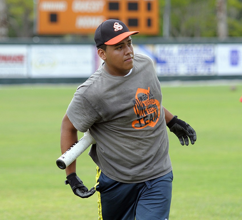 Sarasota High junior Leo Delatorre warms up before participating in a series of hitting drills.