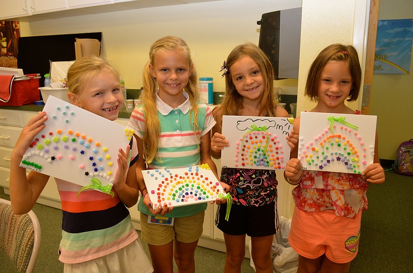 Savannah and Madie Adams, Lilly Mencinsky and Miley Walker show off their beaded rainbow pictures.