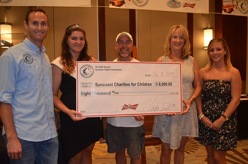 Mason Tush, Tarpon Queen Danielle DeSildesto and Brendan Coudal presented Julie Brown and Brittany Parker of the Suncoast Charities for Children with a check.