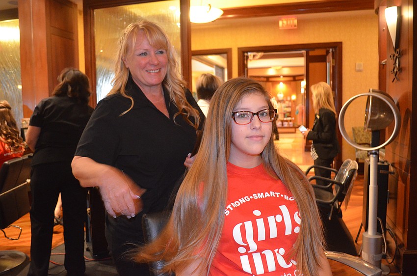 Olivia Arce has her hair done by Sharyn McCormick.