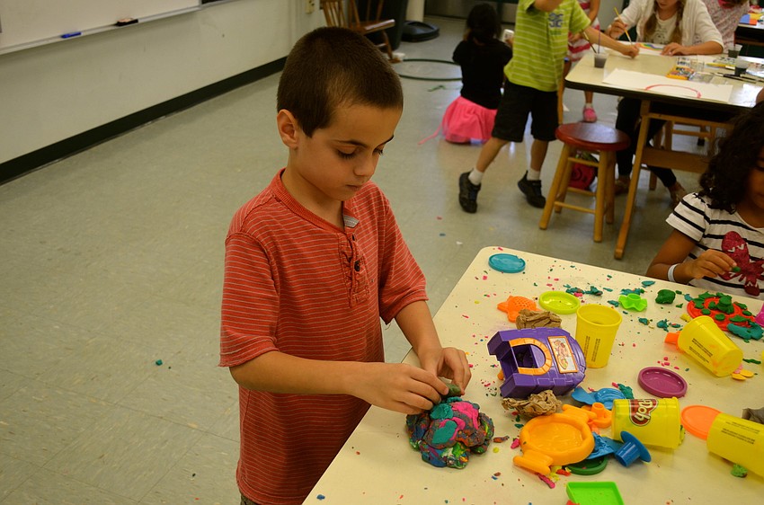Andrew Winehell squishes and shapes his Play-Doh.