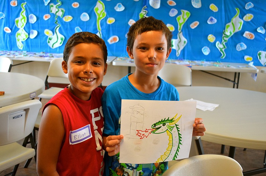 Elliot Santaella and Giancarlo Cintron show off artwork they created.