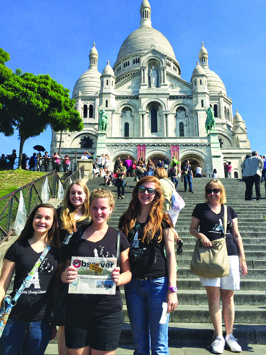UNIVERSAL LANGUAGE. Members of Sarasota Young Voices read their Longboat Observer on the steps of Sacre Coeur, in Montmartre, Paris.