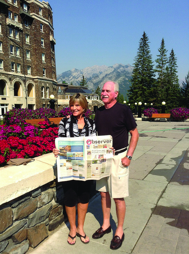 HIGH POINTS. Sunny and Rich McGrath catch up on their hometown news outside the Fairmont Banff Springs hotel in Alberta, Canada. The couple enjoyed seeing mountains and waterfalls on the scenic drive from Vancouver to Banff.