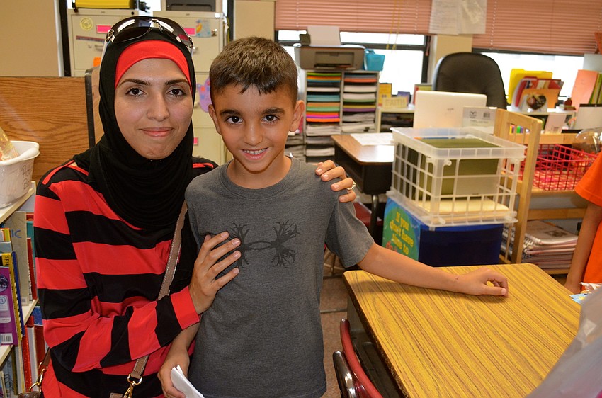 Maram and Nour Al-Absi visit the school's classrooms.