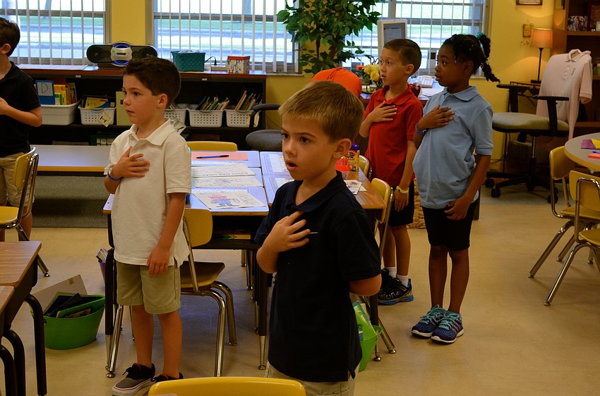 Dehlia Garrity's first-grade class says the Pledge of Allegiance.