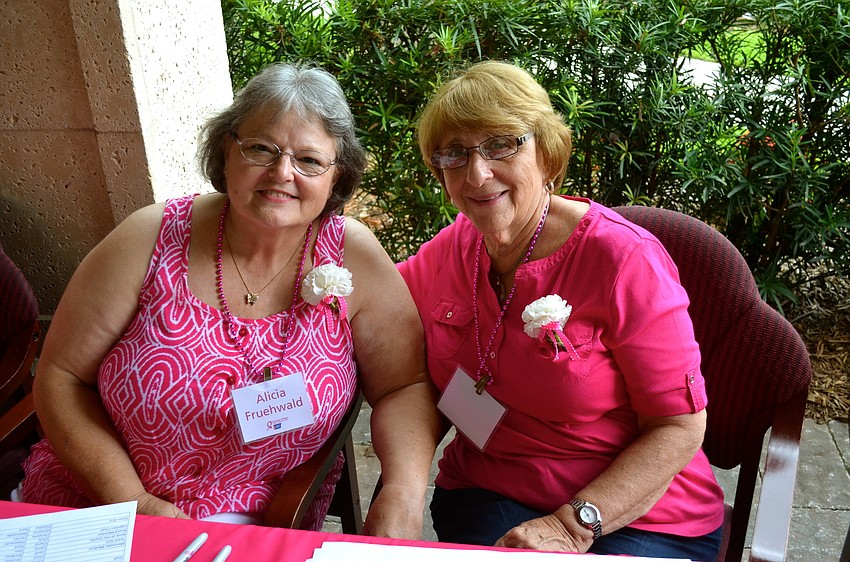 Alicia Fruehwald and Elaine Nutlay greet guests near the doorway.